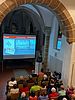 Auf einer großen Leinwand erläutert Archäologe Claus Vetterling den zahlreichen Zuschauern in der St. Gereons-Kapelle die historischen Funde.